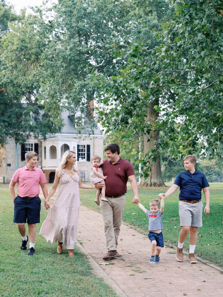 A family walking and holding hands at a Richmond fall mini session by Katie Stansfield Photography.