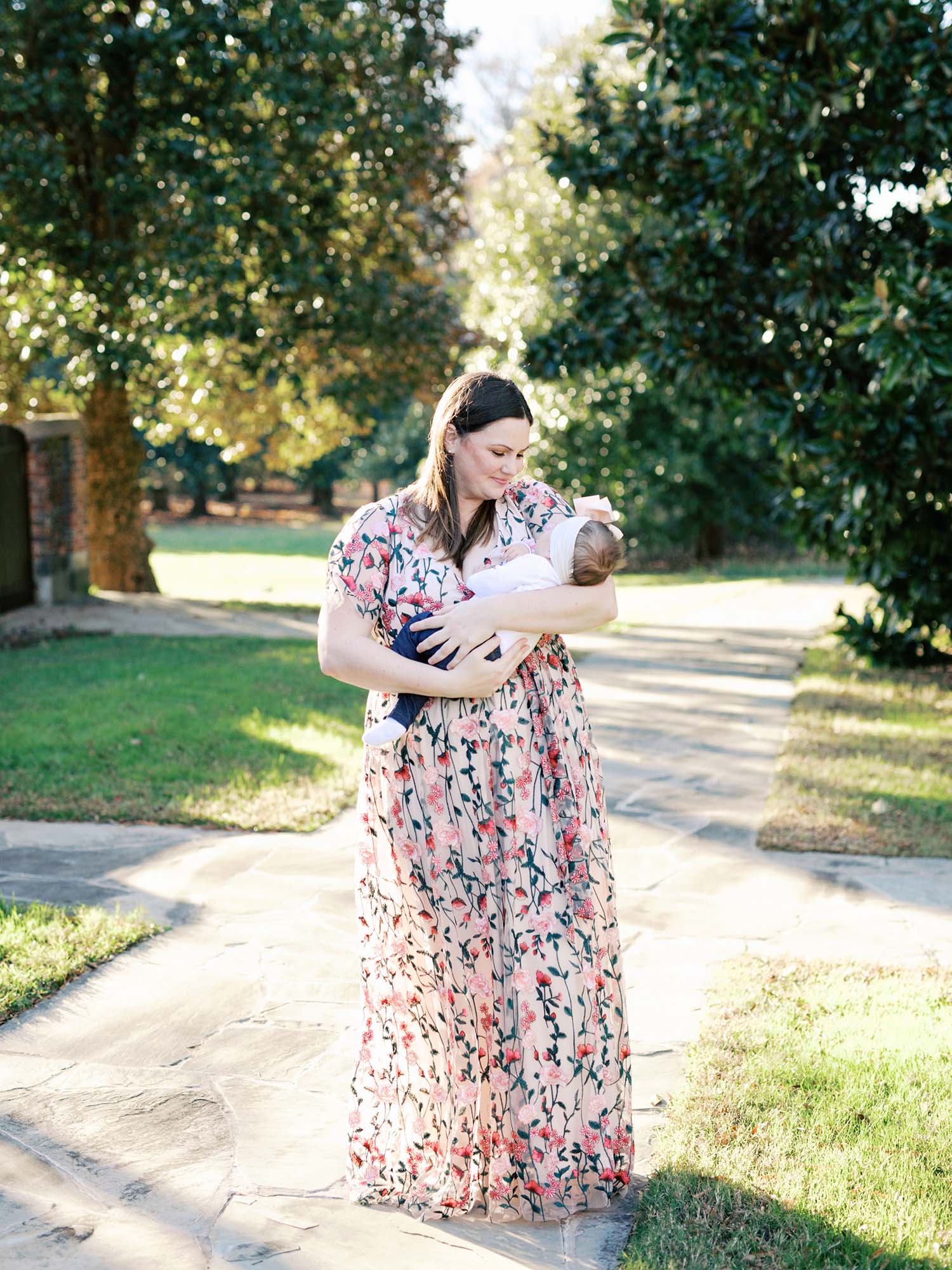A mom cradling her baby at a family photography session at Agecroft Hall and Gardens in Richmond, VA by Katie Stansfield Photography.