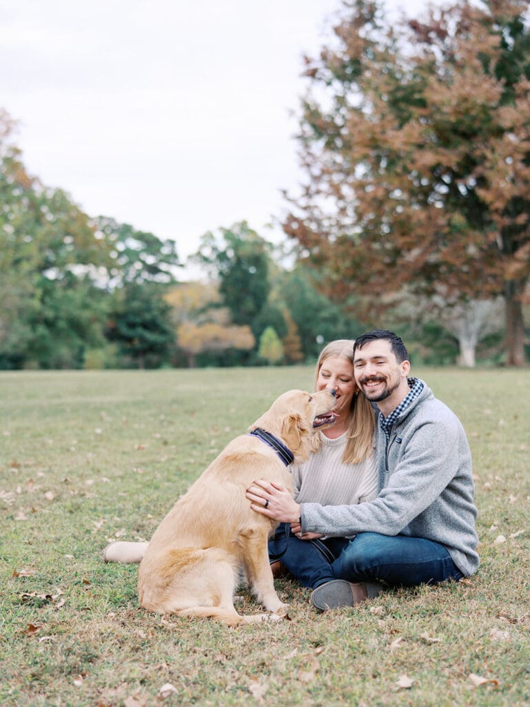 A couple smiling with their dog by Katie Stansfield Photography, a Midlothian photographer.