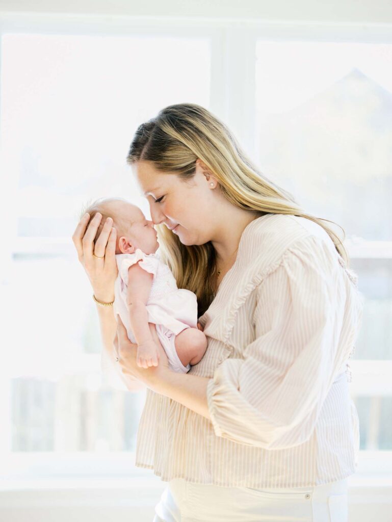 A mom touching noses with her baby at a newborn session by Katie Stansfield Photography.