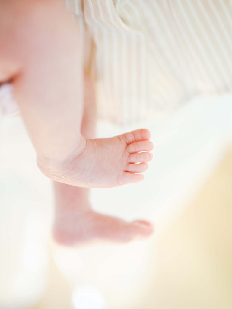 A close-up of a baby's feet at the best time of day for newborn photos by Katie Stansfield Photography.