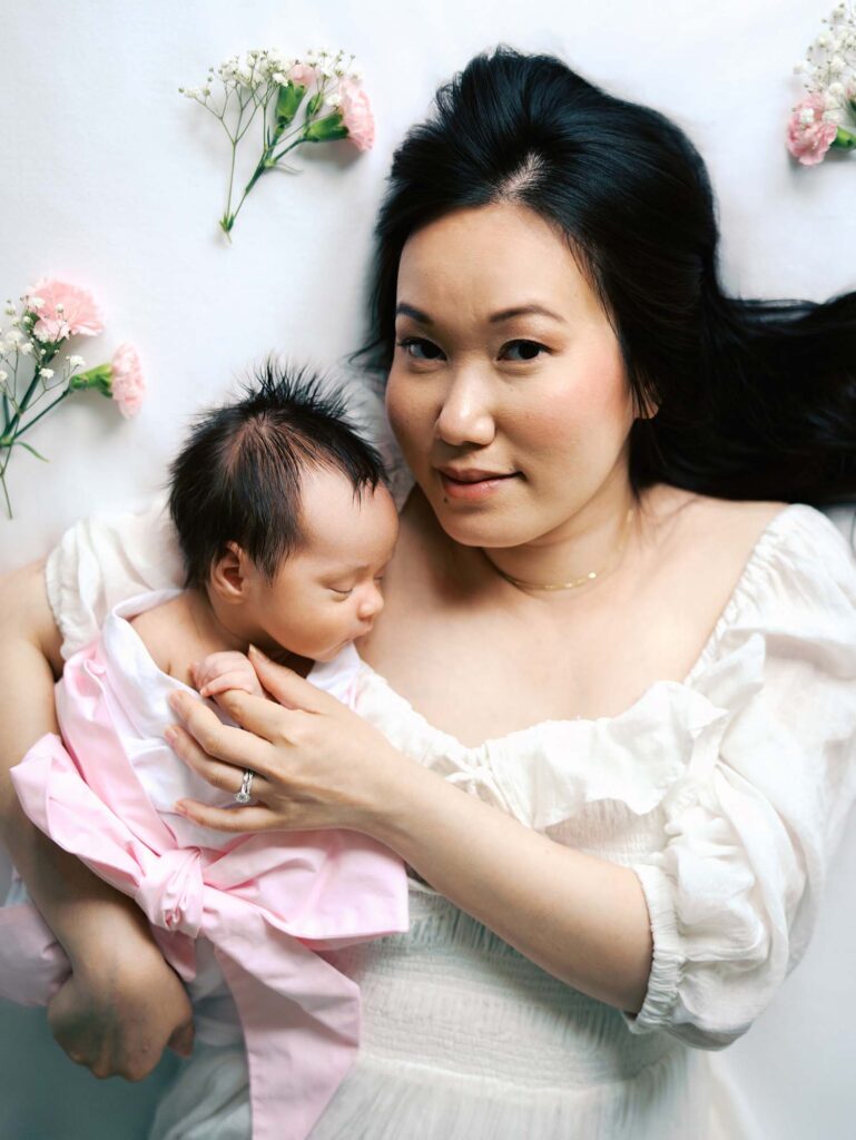 A mom and baby laying down at an in-home session by Katie Stansfield Photography, a Midlothian newborn photographer.