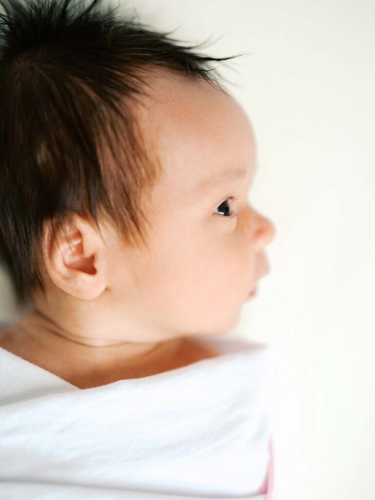 A close-up of a baby's face at an in-home session by Katie Stansfield Photography, a Midlothian newborn photographer.