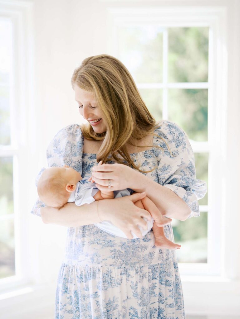 A mom smiling down at her baby by Katie Stansfield Photography, an Ashland VA newborn photographer.