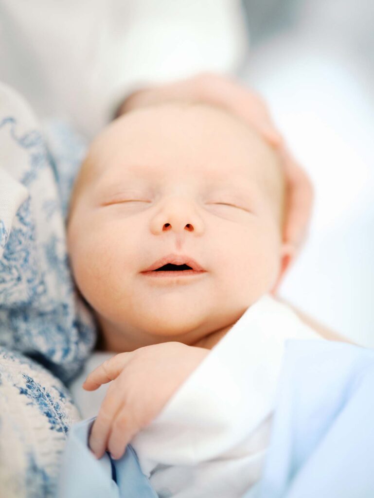 A close-up of a baby's face at a newborn session by Katie Stansfield Photography.