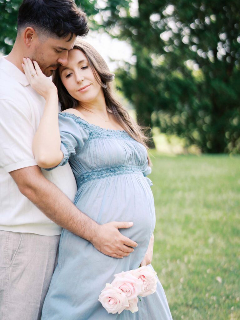 A couple holding mom's pregnancy bump by Katie Stansfield Photography, a Tuckahoe maternity photographer for western Henrico families.