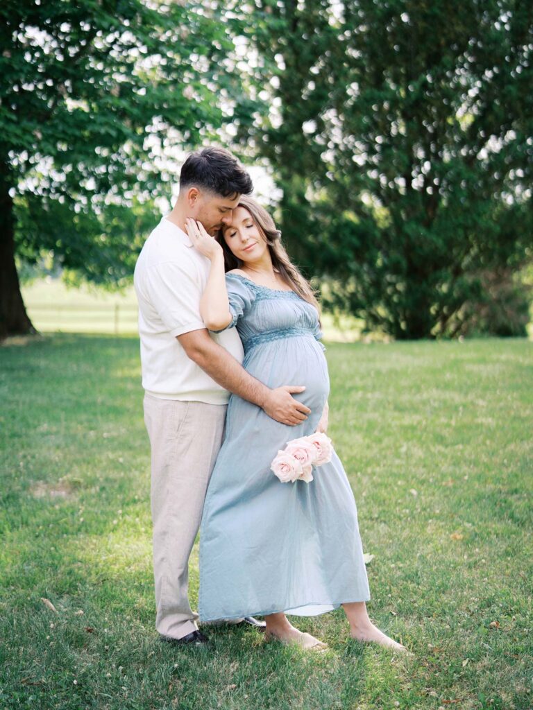 A couple holding mom's pregnancy bump by Katie Stansfield Photography, a Tuckahoe maternity photographer for western Henrico families.