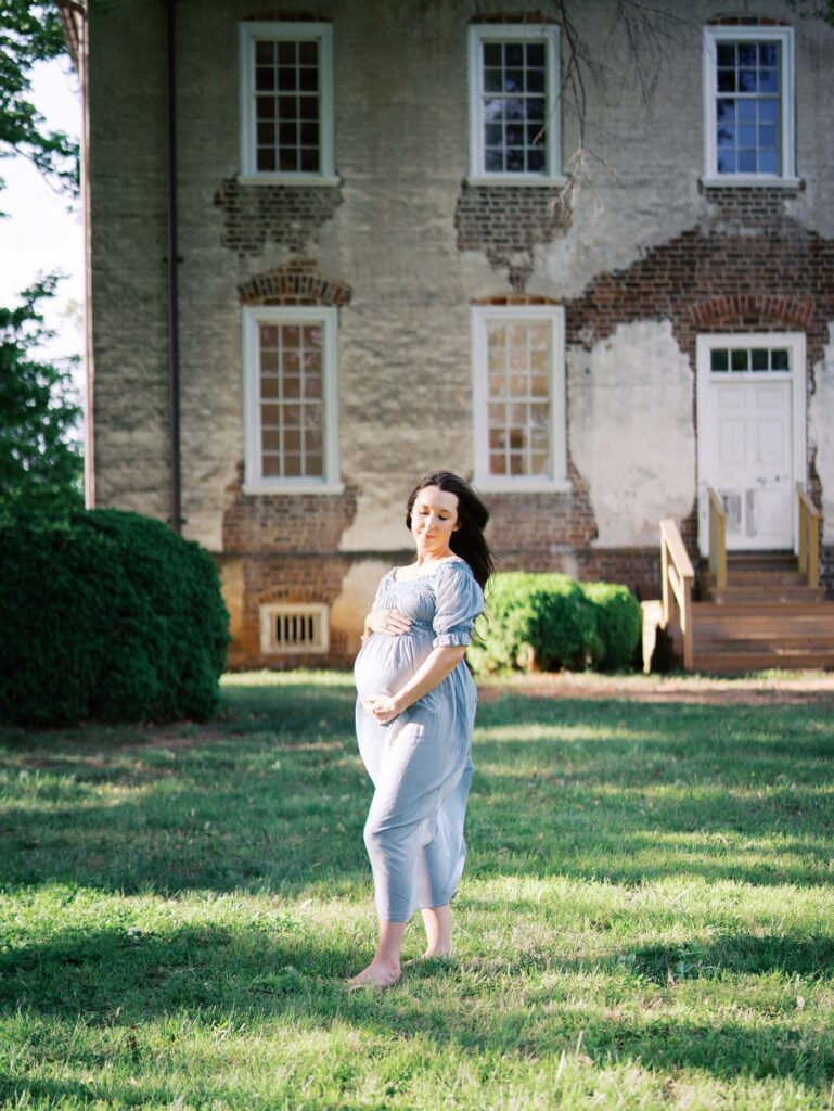 A pregnant mom holding her baby bump at a Tuckahoe maternity photography session by Katie Stansfield Photography, a photographer for western Henrico families.