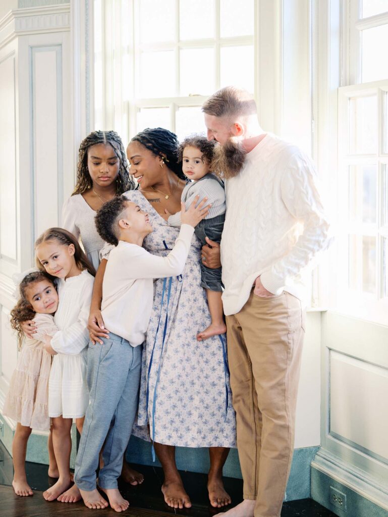 A family smiling at each other at a session to show what to look for in a photograpehr for your family in Richmond, VA by Katie Stansfield Photography.