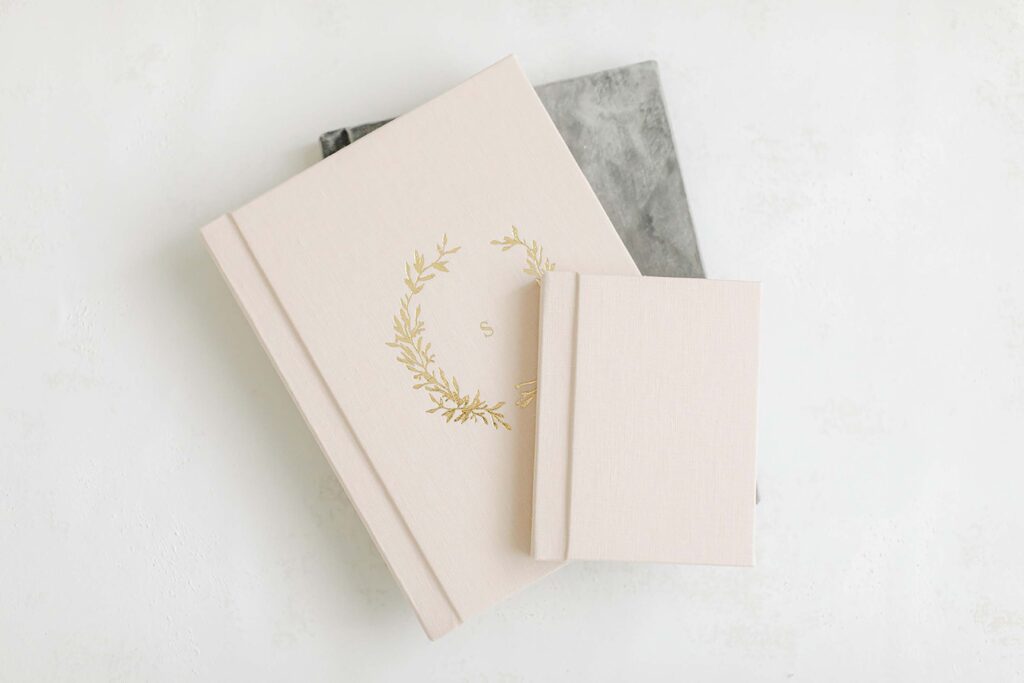 Three albums stacked on top of each other that are available for clients working with Katie Stansfield Photography, a Richmond photographer.