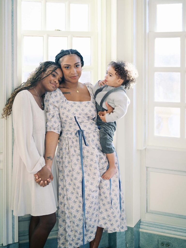 A mom holding a toddler as she holds hands with her daughter at a family session by Katie Stansfield Photography, a Richmond photographer.