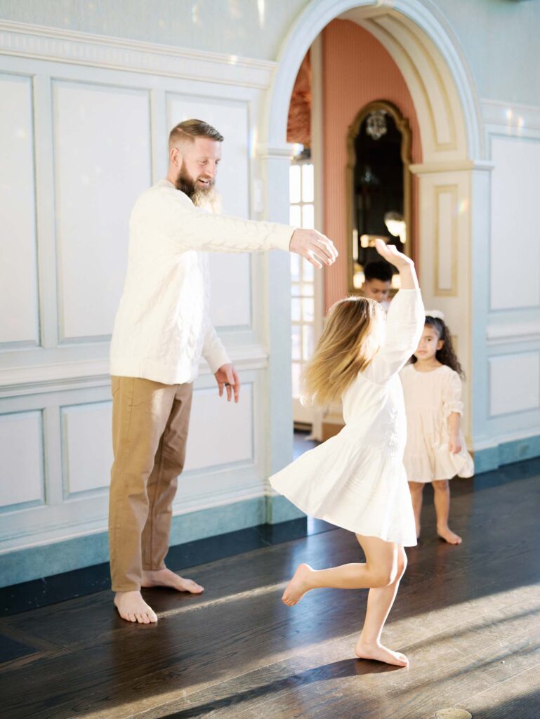 A dad and his daughter dancing at a session to show how to choose a photographer for your family in Richmond, VA by Katie Stansfield Photography.
