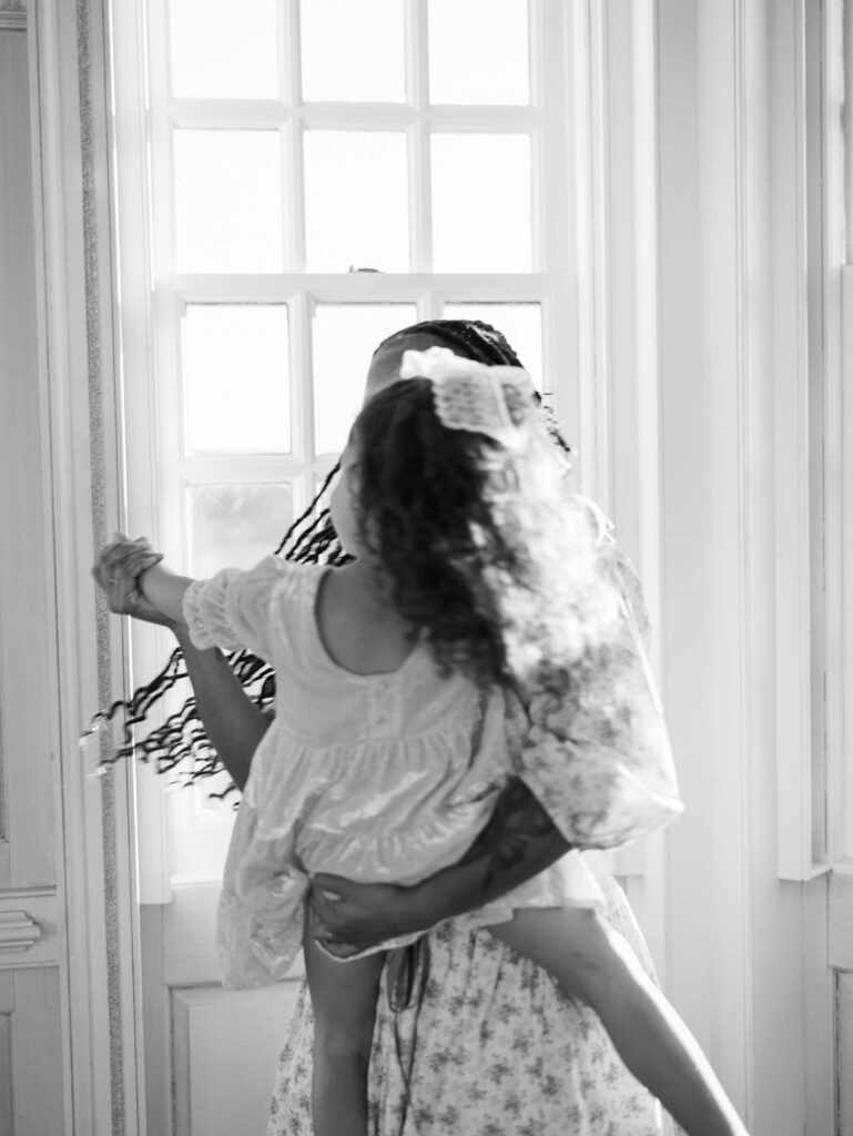 A mom and her daughter dancing at a session to show what to look for in a photographer for your family in Richmond, VA by Katie Stansfield Photography.