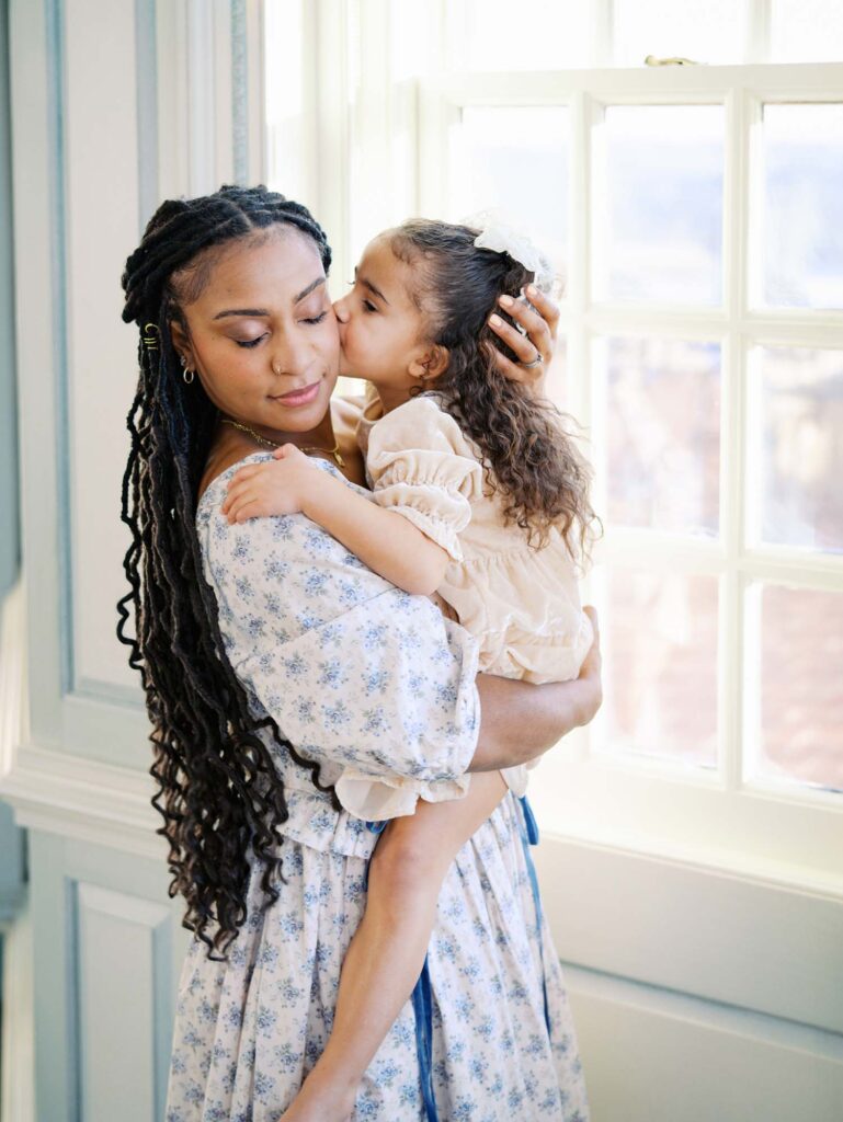 A daughter kissing her mom to show how to choose a photographer for your family in Richmond, VA by Katie Stansfield Photography.