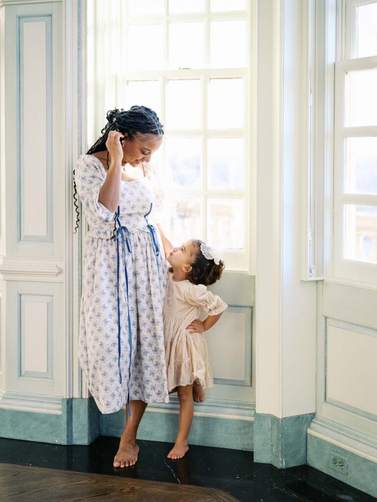 A mom and her daughter smiling at each other at a session to show how to choose a photographer for your family in Richmond, VA by Katie Stansfield Photography.