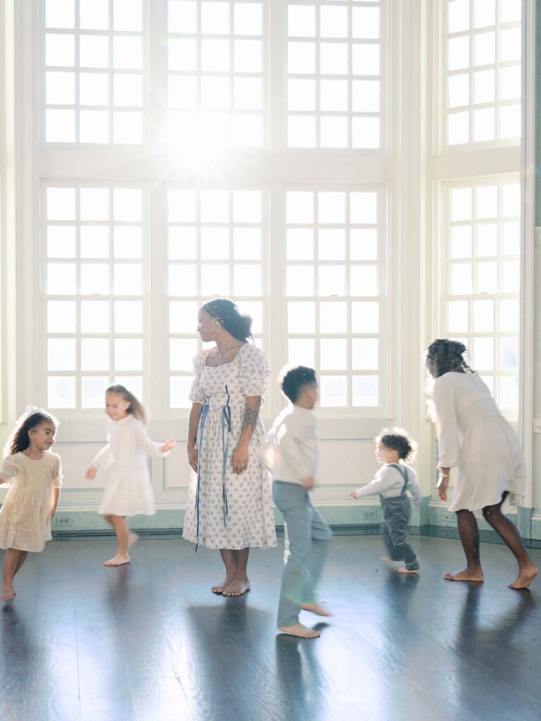 Children running in circles around their mom at a family session by Katie Stansfield Photography, a Richmond photographer.
