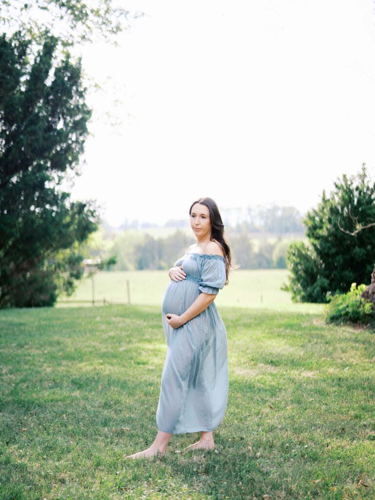 A mom holding her baby bump by Katie Stansfield Photography, a maternity photographer in Henrico County, VA.