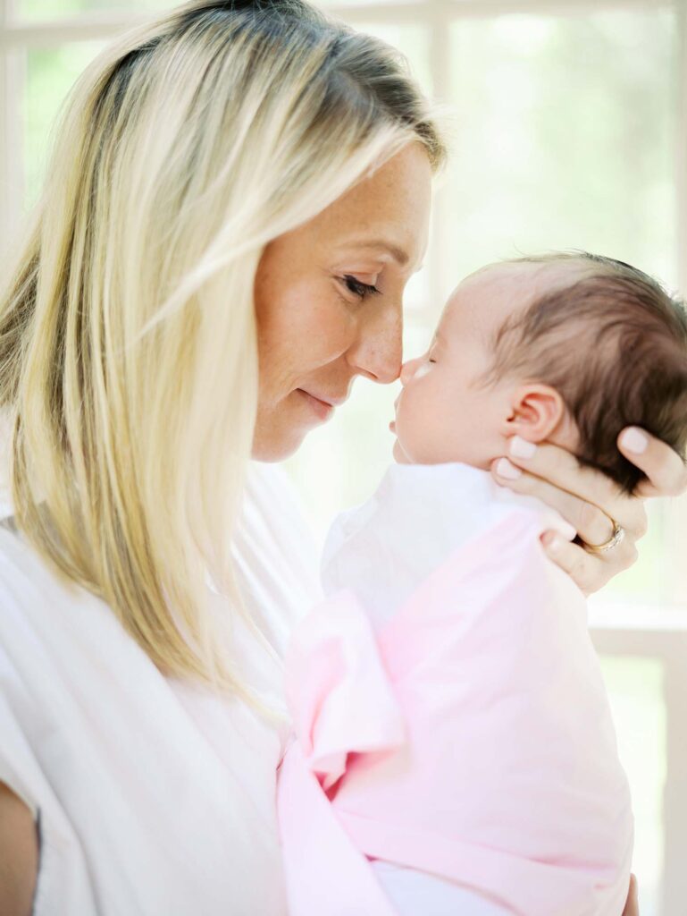 A mom and baby touching noses in their home, one of the newborn photo locations in Richmond VA, by Katie Stansfield Photography.