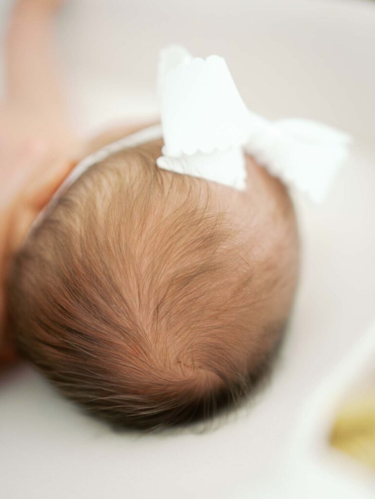 A close-up of a baby's head of hair at a newborn session by Katie Stansfield Photography.
