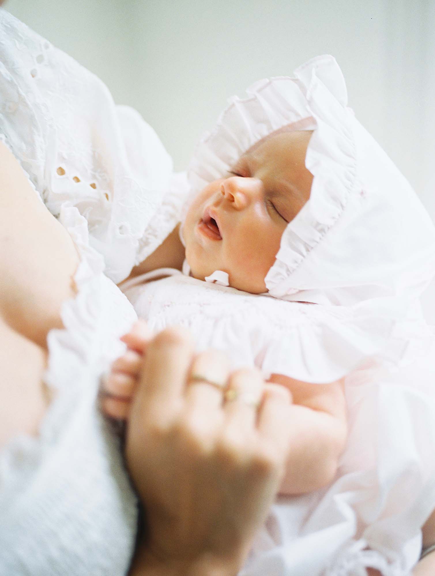 A close-up of a baby in mom's arms by Katie Stansfield Photography, a Bon Air newborn photographer.
