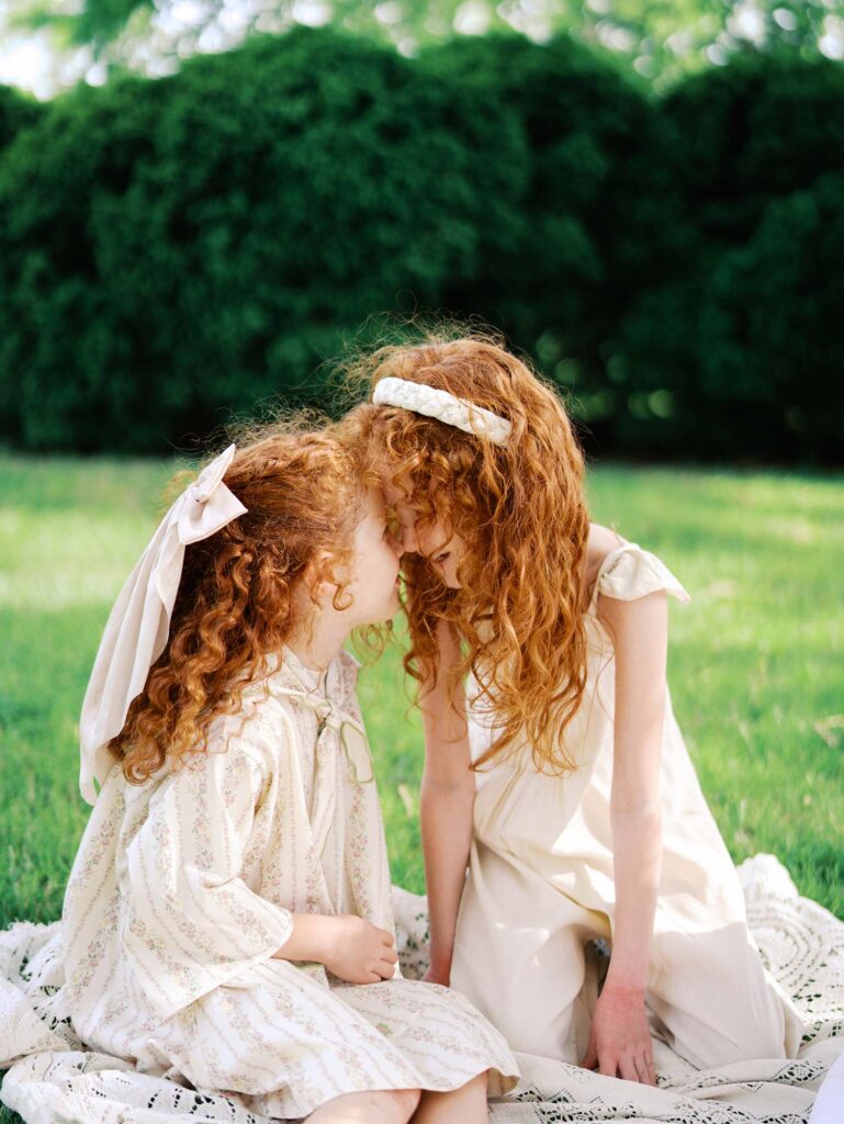 Two girls touching foreheads by Katie Stansfield Photography, a family photographer in Short Pump VA.