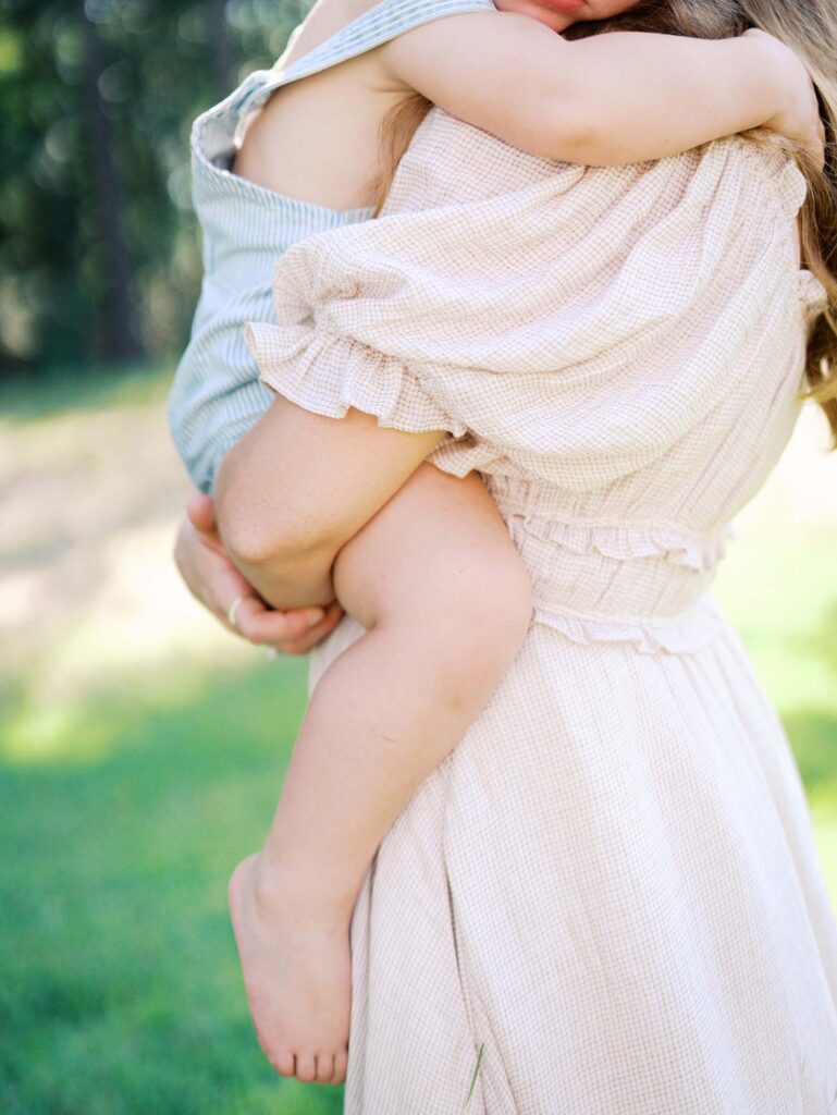 A close-up of a toddler snuggling mom at an at-home family session by Katie Stansfield Photography, a Chesterfield family photographer.