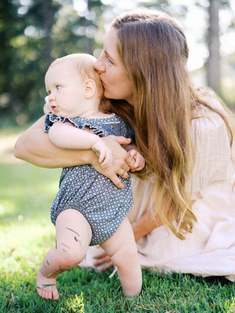 Mom kissing baby's head at an at-home family photography session by Katie Stansfield Photography.