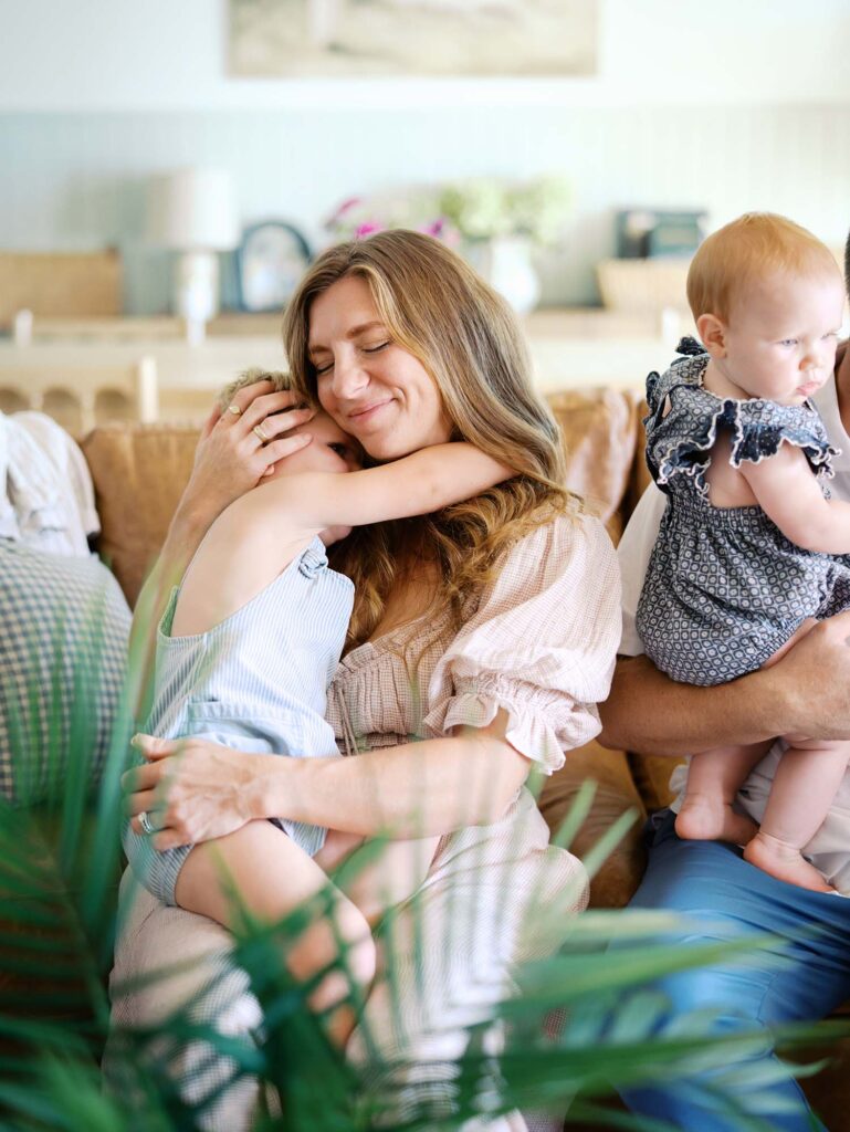 A toddler snuggling mom at an at-home Chesterfield family photo session by Katie Stansfield Photography.