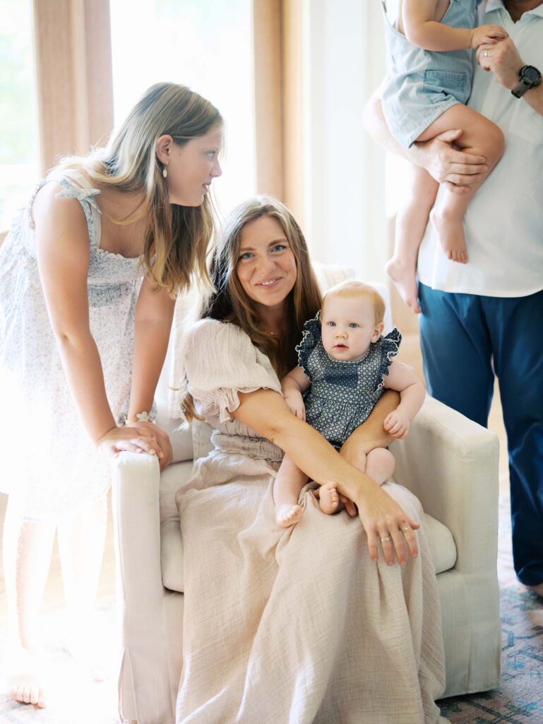 Mom smiling while surrounded by her kids at an at-home family photography session by Katie Stansfield Photography.