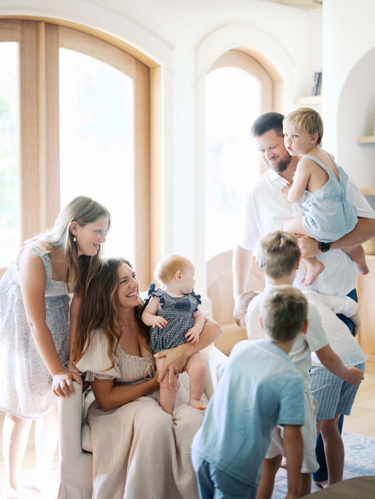 A family smiling at each other at an at-home family session by Katie Stansfield Photography, a Chesterfield family photographer.