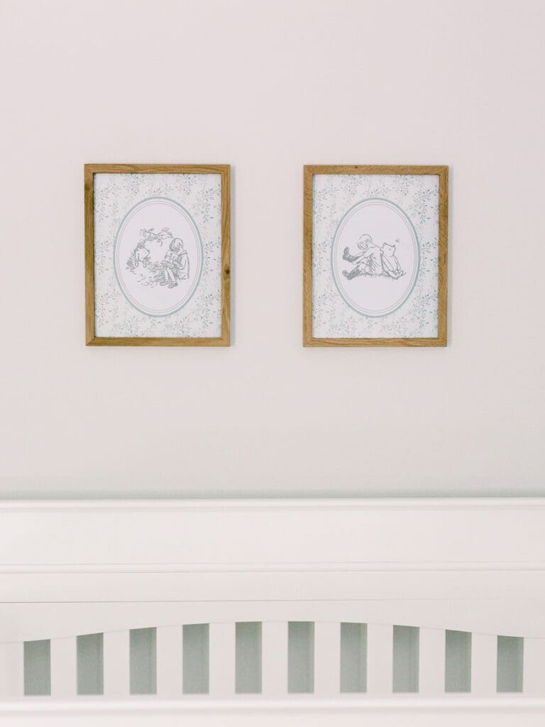 Two natural wooden framed prints of vintage Winnie the Pooh at a Richmond newborn nursery photography session by Katie Stansfield Photography.