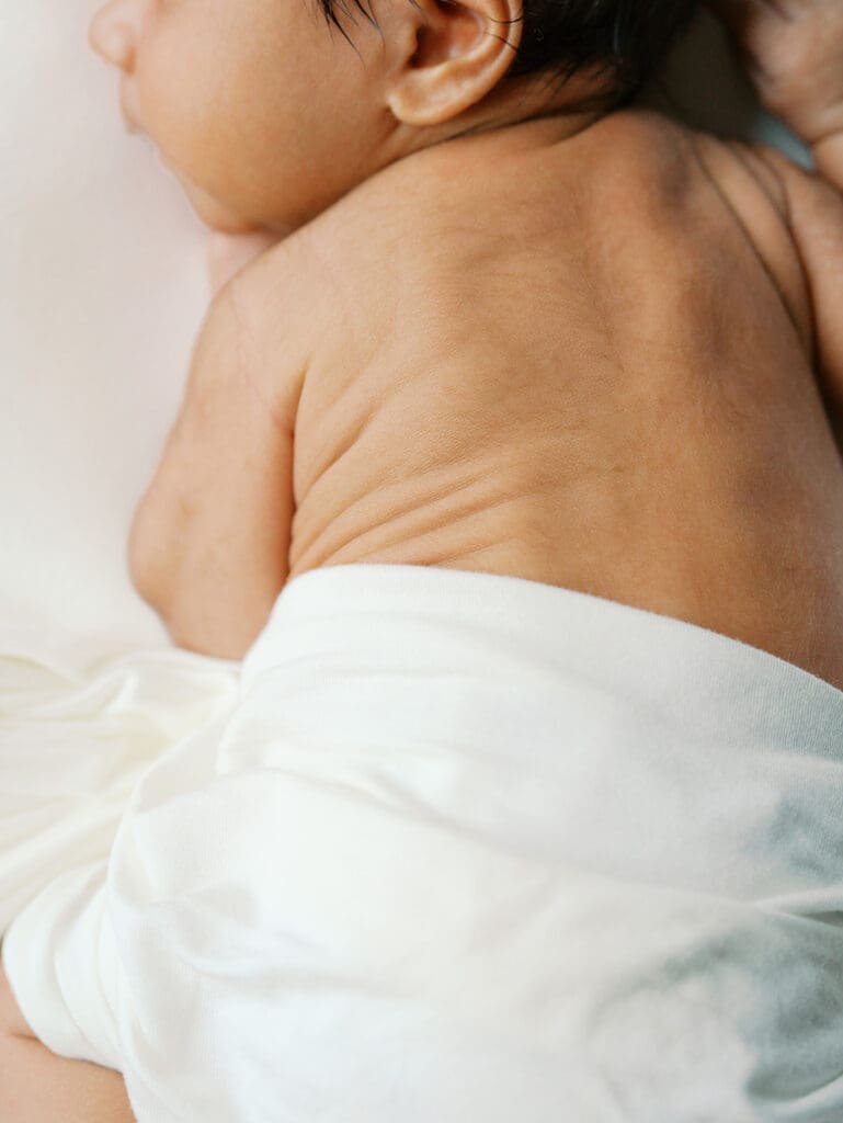 A close-up of a baby's back wrinkles during a session by Katie Stansfield Photography, a Chesterfield newborn photographer.