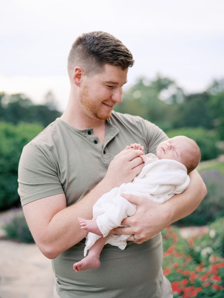 A dad holding his baby at a newborn session by Katie Stansfield Photography.